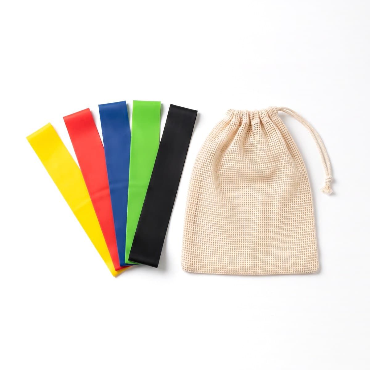 Five flat latex loop bands in five colours fanned out beside a drawstring mesh bag